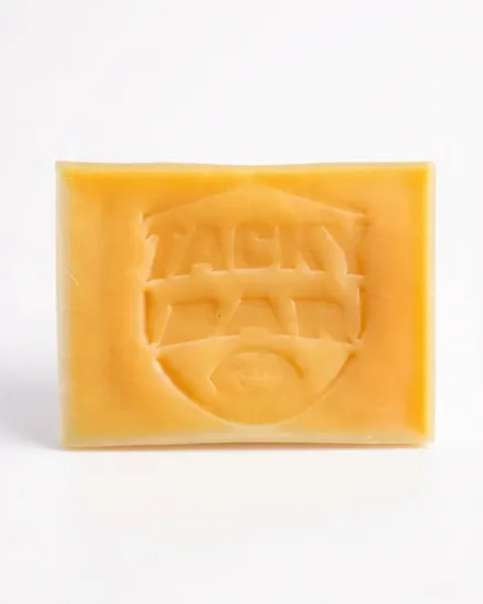 Tacky Bar: an amber wax bar with the Tacky Bar shield pressed into the top