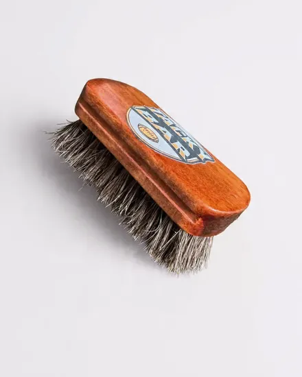 The wood-backed Tacky Bar brush with the Tacky Bar logo